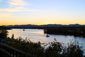 Naklejka na ściany i meble Hudson River at dusk in Hudson with lighthouse and boats