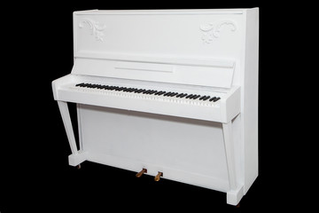 white piano isolated on a black background