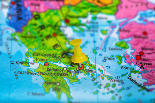 Athens in Greece pinned on colorful political map of Europe. Geopolitical school atlas. Tilt shift effect.