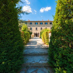 Fototapeta na wymiar Traditional Italian Tuscany Farmhouse - rural villa surrounded by nature garden 
