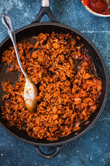 Bolognese sauce in frying pan. top view.