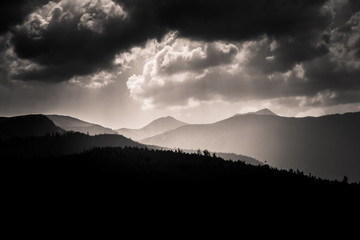 Dramatic clouds over Carpathian mountains in gray scale