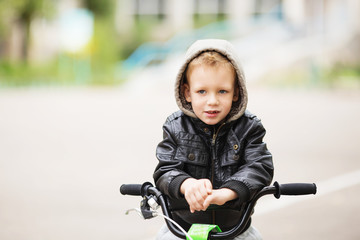 Fototapeta na wymiar portrait of adorable little urban boy wearing black leather jack