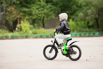 Naklejka premium portrait of adorable little urban boy wearing black leather jack