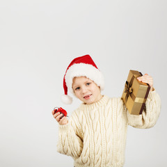 Portrait of happy joyful beautiful little boy wearing Santa hat