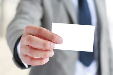 Man holding white business card