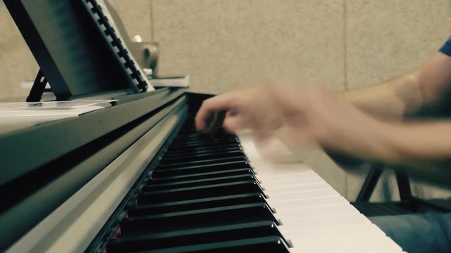 Hands on the piano roll close-up