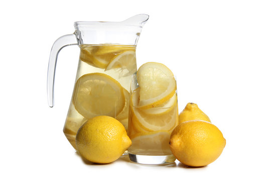Glass jars with lemon on a white background