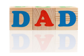 Dad word formed by colorful wooden alphabet blocks, isolated on white background 