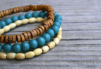 Colorful wooden bracelets on old wooden background.Handcrafted bangles.Handmade wooden bead...