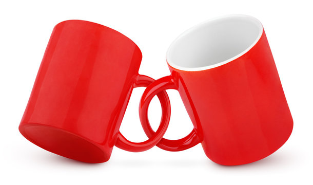 Two coupled red mugs isolated on white background with clipping path