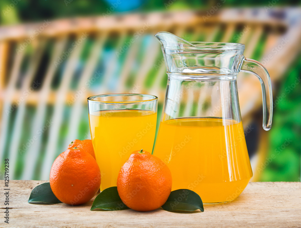 Wall mural orange juice in a glass on a table