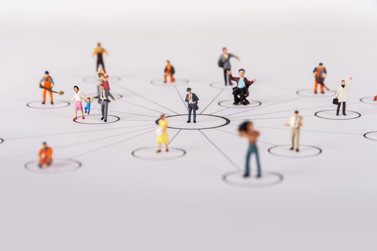 close up of miniature people with social network diagram
