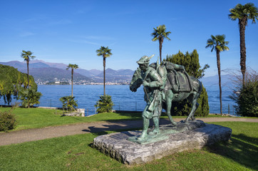 Alpini Soldier Monument in Stresa, Italy. Panoramic view of Lake Maggiore with a bronze monument of Alpini Soldier, Stresa, Piedmont.