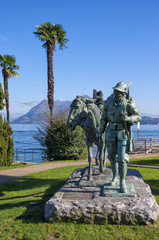 Alpini Soldier Monument in Stresa, Italy. Panoramic view of Lake Maggiore with a bronze monument of Alpini Soldier, Stresa, Piedmont.
