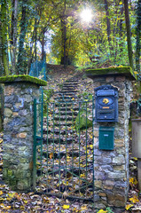 Garden gate and stairs.Romantic garden door and stairs of an Italian house. Sunbeams come through the trees. Stresa, Piedmont,Italy