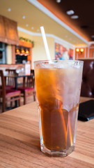 Glass of ice lemon tea in luxury restaurant.