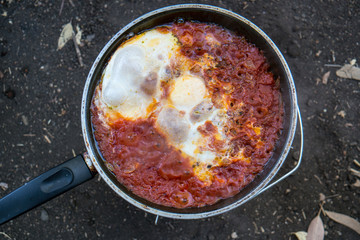 Shakshuka being prepared on a camping site
