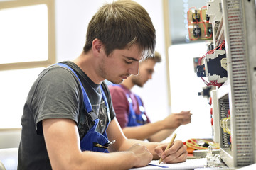 Electrician student taking notes
