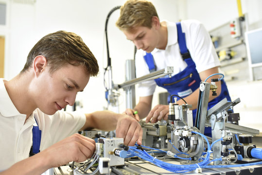 Two Students Working With Pneumatics Component Parts