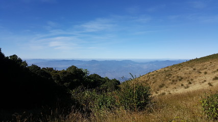 Beautiful mountain landscape, with mountain peaks covered with forest and a blue sky.