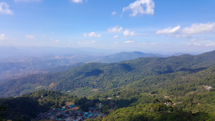 Beautiful mountain landscape, with mountain peaks covered with forest and a blue sky.