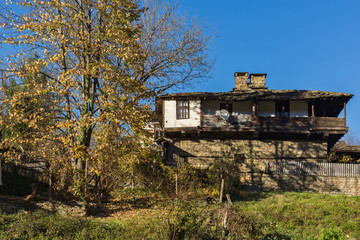 Panorama with Old house and autumn tree with courtyard in village of Bozhentsi, Gabrovo region, Bulgaria