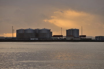 industrial repositories for oil and gas in the harbor at sunset