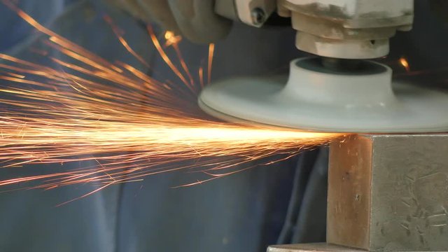 Metal grinder at work with sparks flying all around, Close up, 4K