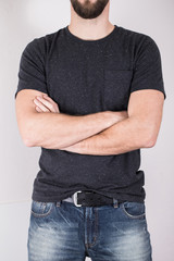 blue jeans of a young man wearing grey blank t-shirt