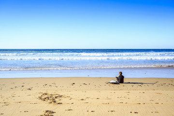 Surfer on wild beach in western Portugal