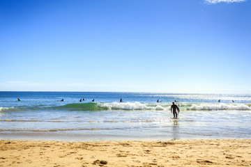 Fototapeta na wymiar Surfers on Beliche Beach, Sagres, Algarve, Portugal