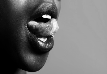 African girl tongue stuck out showing piercing black and white
