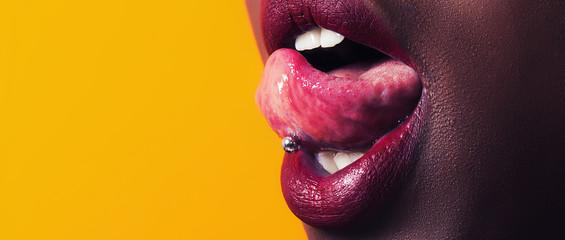 African girl tongue stuck out showing piercing letterbox
