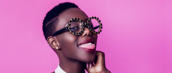 Woman with big eyeglasses sticking out tongue