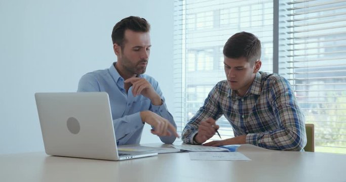 Business meeting - two men talking in the office