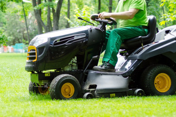 Man is riding the grass cutter