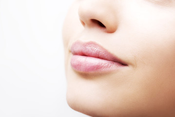 Plump sexy lips and perfect skin on a white background