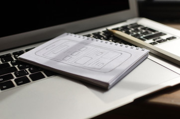 Laptop, sketchbook and pencil