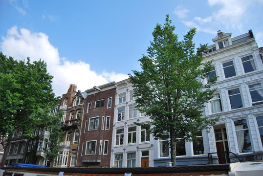 View of facades in Amsterdam in daylight and blue sky