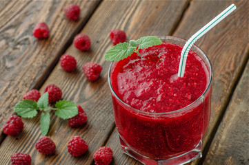 Close-up raspberry smoothie with mint on wood background