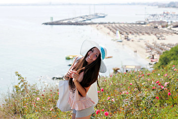 Fototapeta premium Beautiful girl in blue hat smiling and posing for the camera