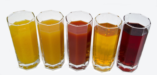 Isolated glasses of juice on white