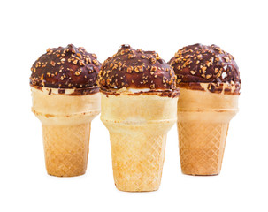 Three ice cream with chocolate icing and nuts in waffle cup