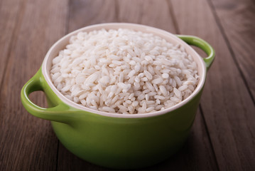 Raw white rice in ceramic pot