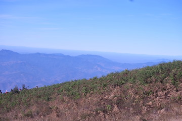 Beautiful mountain landscape, with mountain peaks covered with forest and a blue sky.