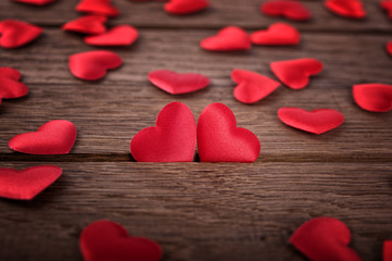 Two hearts on wooden background