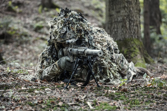 sniper wearing ghillie suit