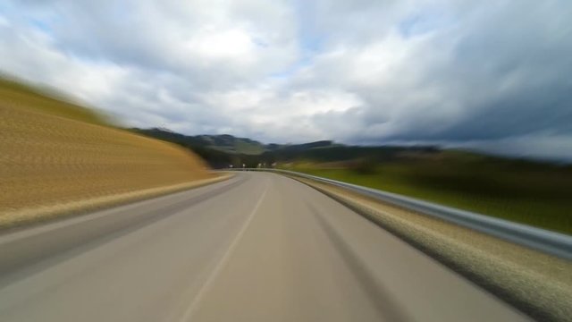 Driving on a rural road in the mountains.Time lapse.