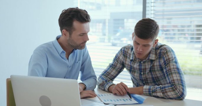 Two businessmen doing financial analysis